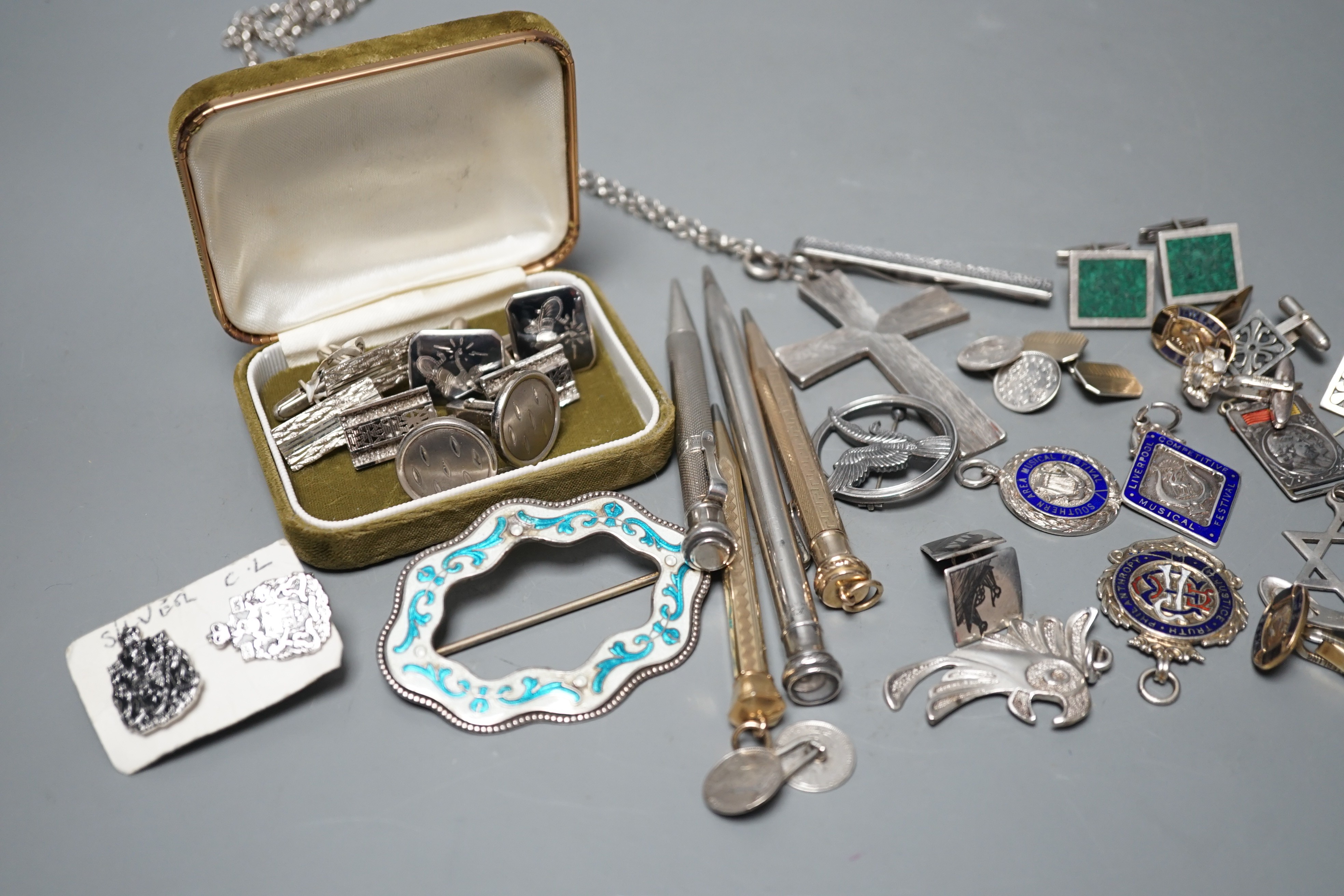 A white gold two colour enamel and diamond chip set Royal Artillery sweethearts brooch